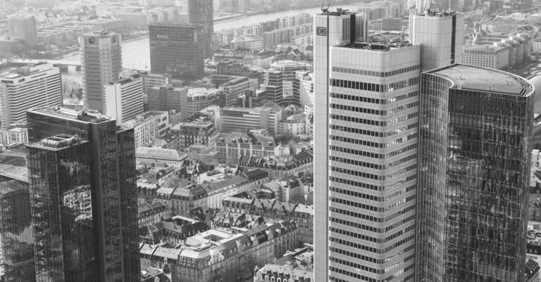 atom bank ai - A stunning aerial view of Frankfurt am Main's modern high-rise skyline in black and white.