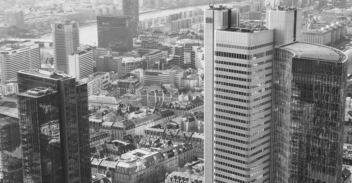 atom bank ai - A stunning aerial view of Frankfurt am Main's modern high-rise skyline in black and white.