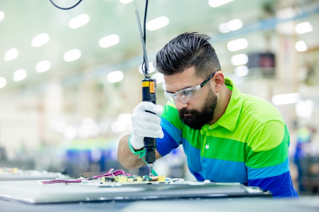 investment ai - a man in a factory working on a piece of equipment