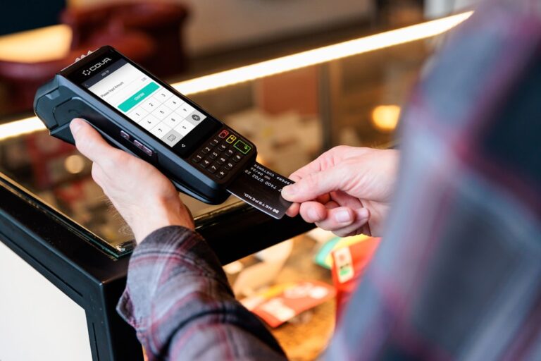 ai stablecoin transactions - a person holding a cell phone in their hand