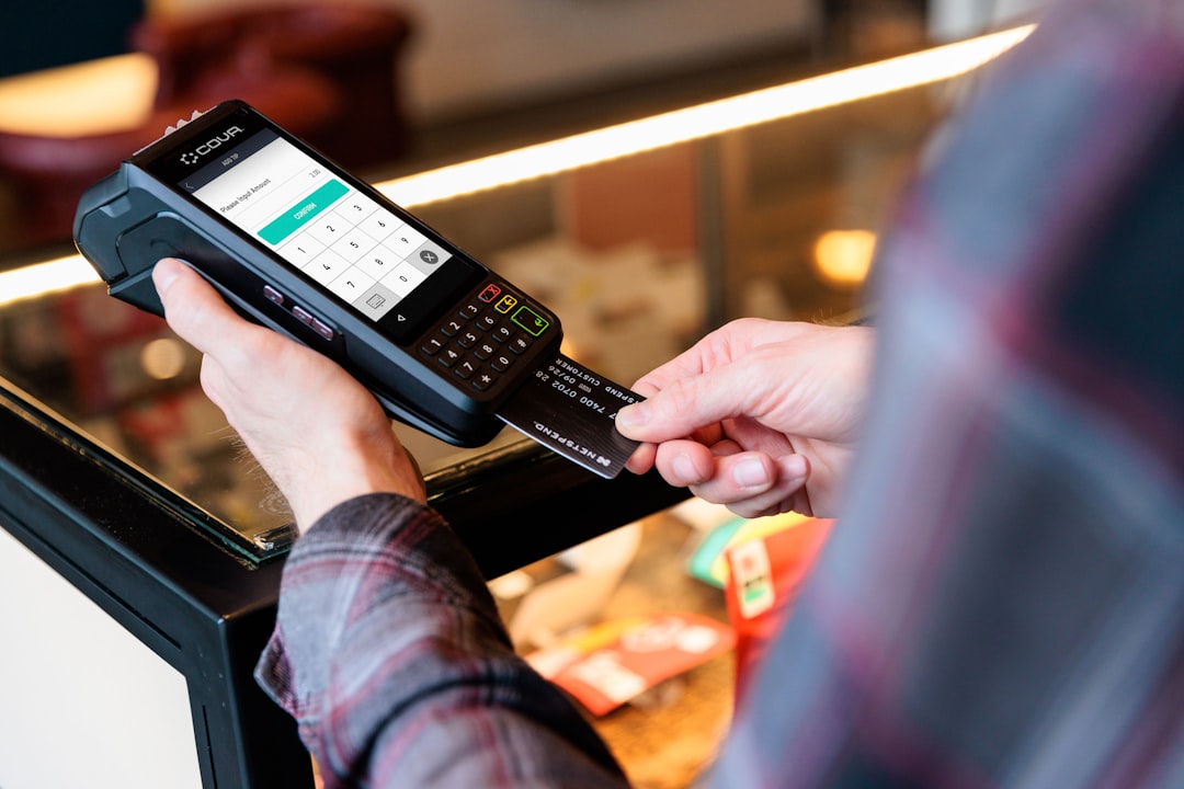 ai stablecoin transactions - a person holding a cell phone in their hand