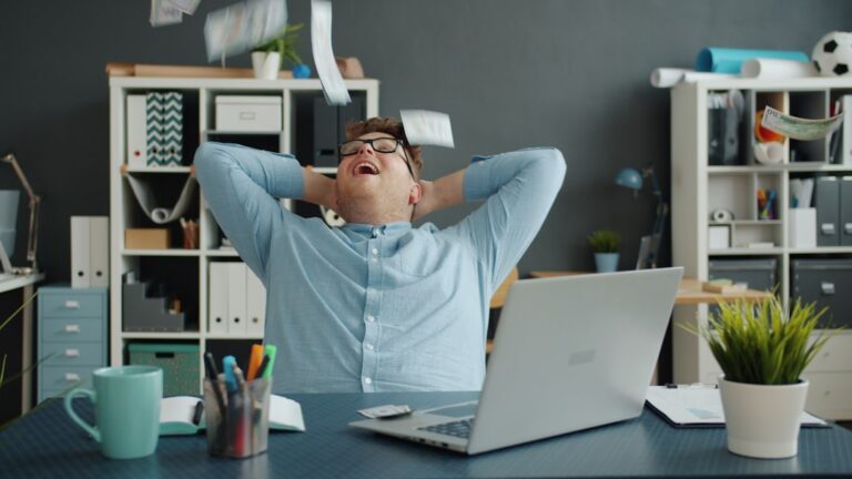 model portfolios projection - Man celebrating success by throwing papers in office