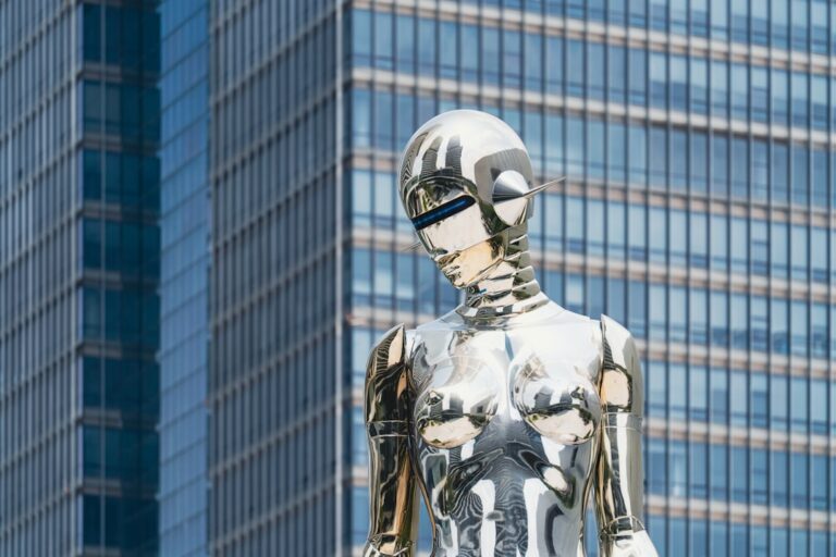 ai in banking - Shiny statue stands in front of a skyscraper.