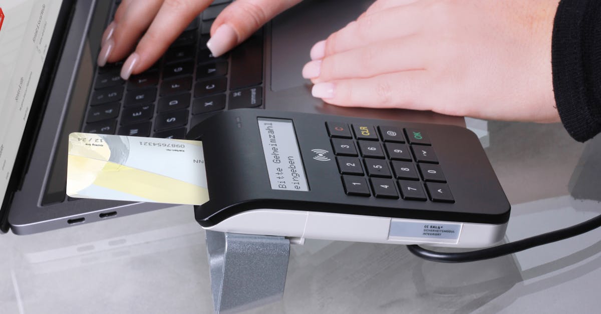 airwallex buys leapfin - Close-up of contactless payment using laptop and card reader, showcasing modern office technology.