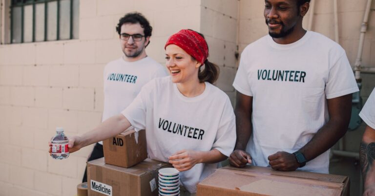 ant group international growth - Volunteers distributing aid at an outdoor donation center, promoting social impact and diver