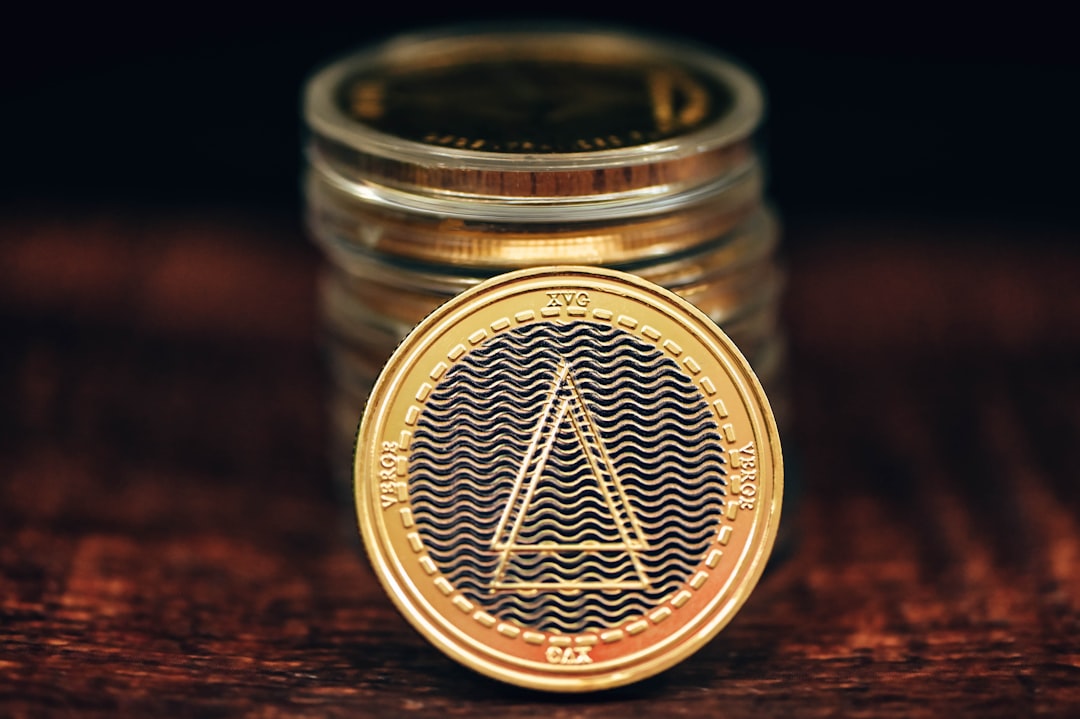 financial crime specialist - a gold coin sitting on top of a wooden table