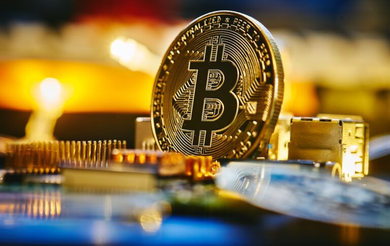 bitcoin etf outflows - a bitcoin sitting on top of a computer chip