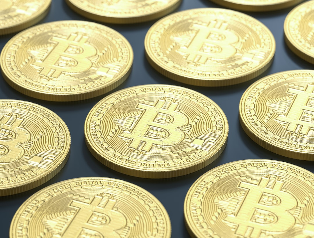 blackrock bitcoin etf - a pile of gold bitcoins sitting on top of a table