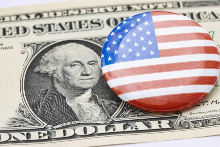 cross-border real-time payments - a button with the american flag on top of a one dollar bill