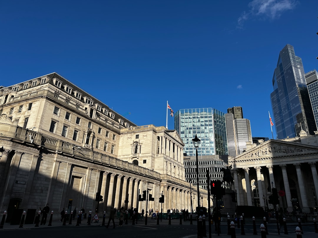stablecoin ownership limits - Modern and historic buildings under a clear blue sky.