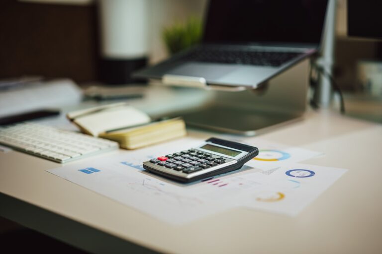 broadcom ai chip - a calculator sitting on top of a table next to a laptop