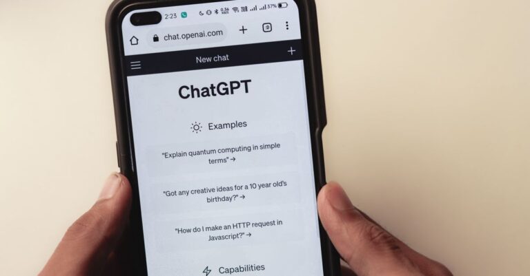 custom chip openai - Close-up of hands holding a smartphone displaying the ChatGPT application interface on the screen.