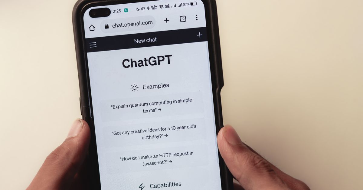 custom chip openai - Close-up of hands holding a smartphone displaying the ChatGPT application interface on the screen.