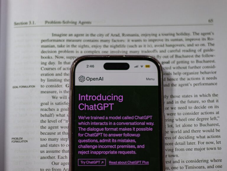 experian chatgpt app - a cell phone sitting on top of an open book