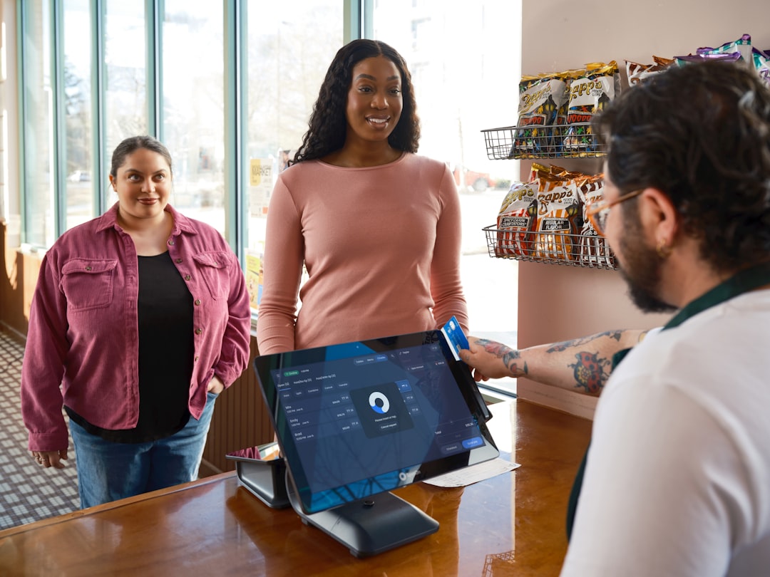 fis core banking platform - Customers interacting with a cashier and a point-of-sale system.