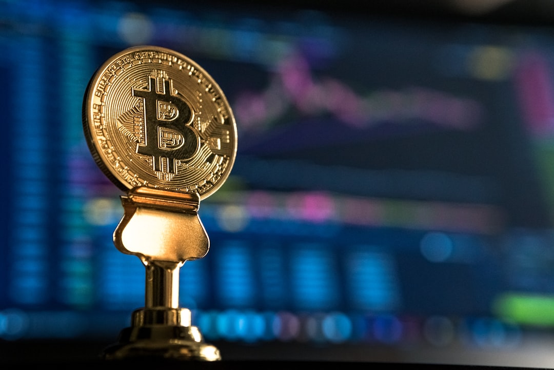 crypto vc money - selective focus photo of Bitcoin near monitor
