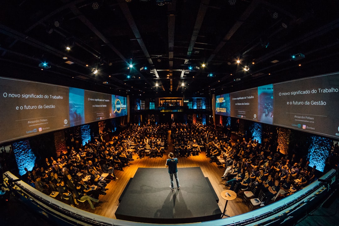 techcrunch disrupt stages - people sitting on chairs watching a game