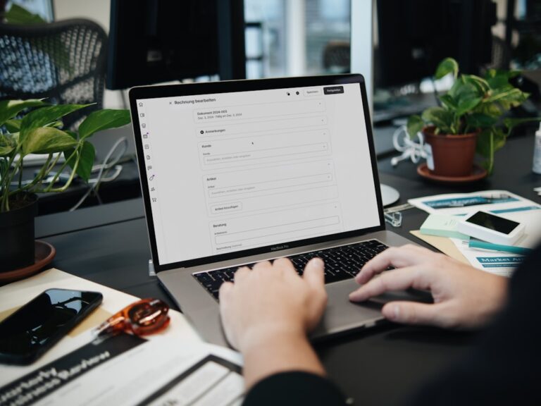 europe invoice priority - A person typing on a laptop on a desk