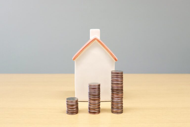 fca mortgage reforms - a house and stacks of coins on a table