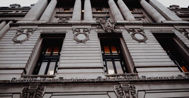 climate risk modelling - Low angle view of a neoclassical architectural facade showcasing detailed columns and decorative ele