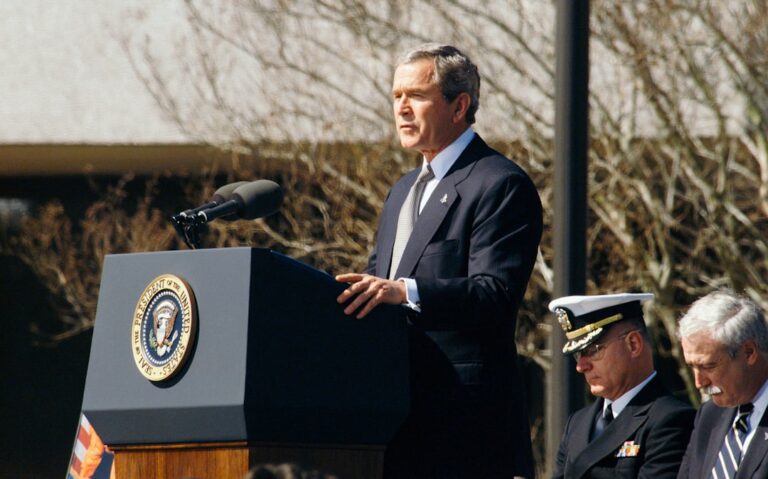 fed rate changes - George W. Bush standing on lectern during daytime