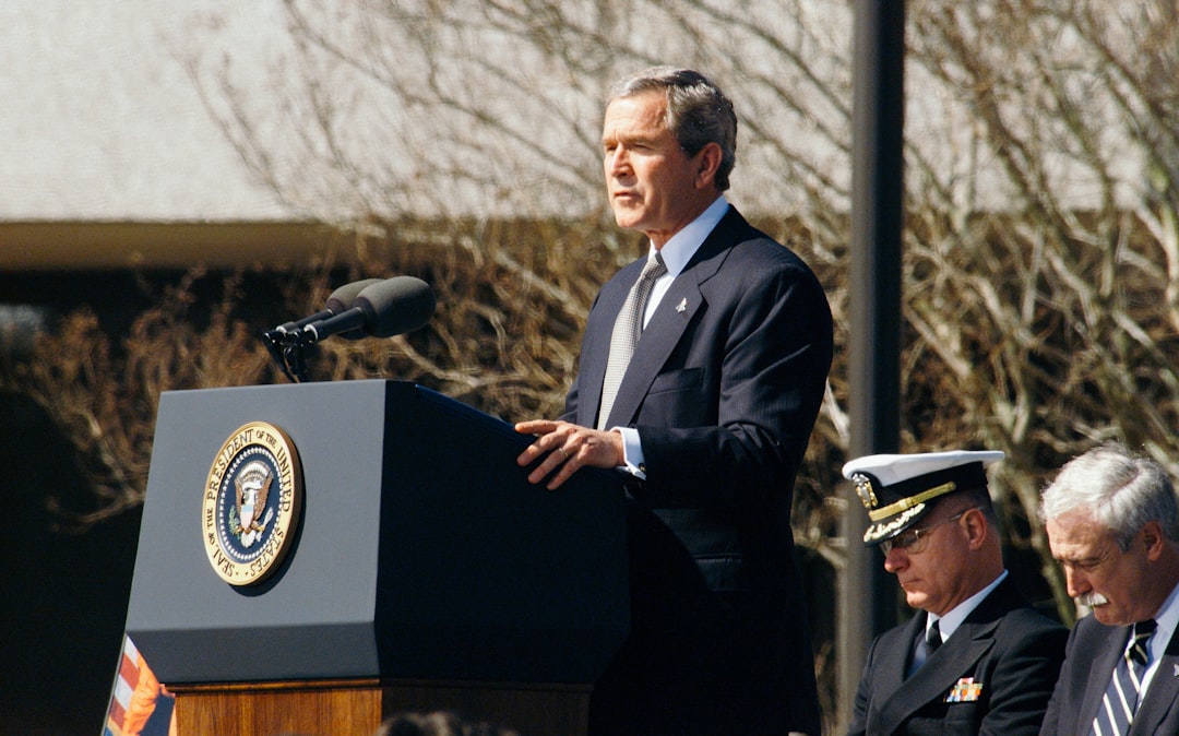 fed rate changes - George W. Bush standing on lectern during daytime