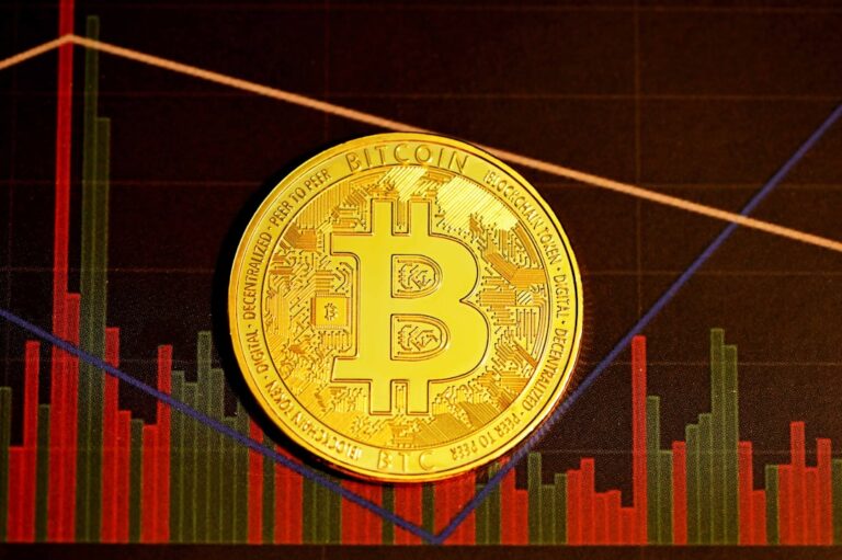 strategy shares fall - gold round coin on red and black textile