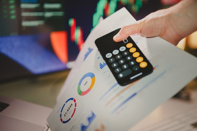 AI credit scoring - a person holding a calculator over a piece of paper