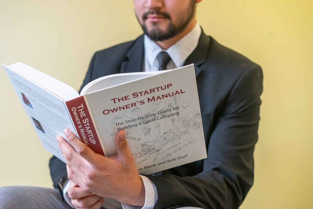 ai startup ipo - a man in a suit is reading a book