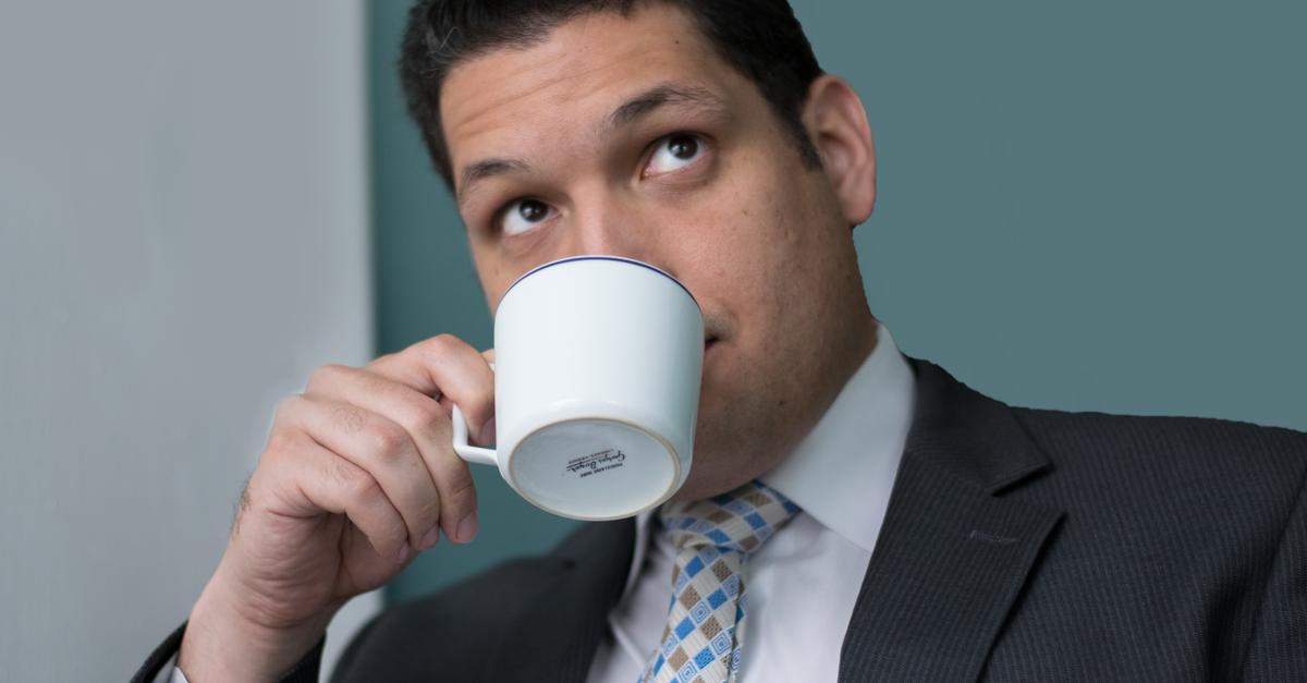 jpmorgan ceo successors - Portrait of a businessman enjoying a coffee break while wearing a suit.