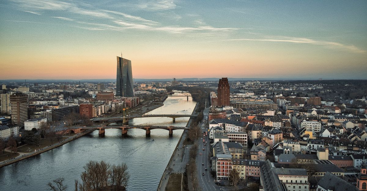 binance mica fight - A stunning aerial view of Frankfurt am Main featuring the iconic ECB Tower and the Main River at sunset.