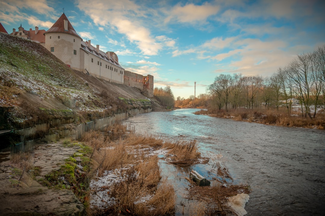 latvijas banka license - white concrete building near river under blue sky during daytime