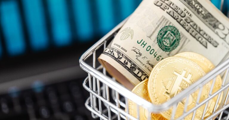rebuilding payments landscape - Close-up of bitcoin coins and US dollars in a shopping cart on a laptop, symbolizing digital
