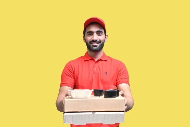 quick-commerce valuation - a man holding a stack of boxes