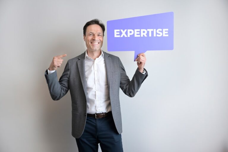 retiree small business ideas - A man points to himself holding an "expertise" sign.