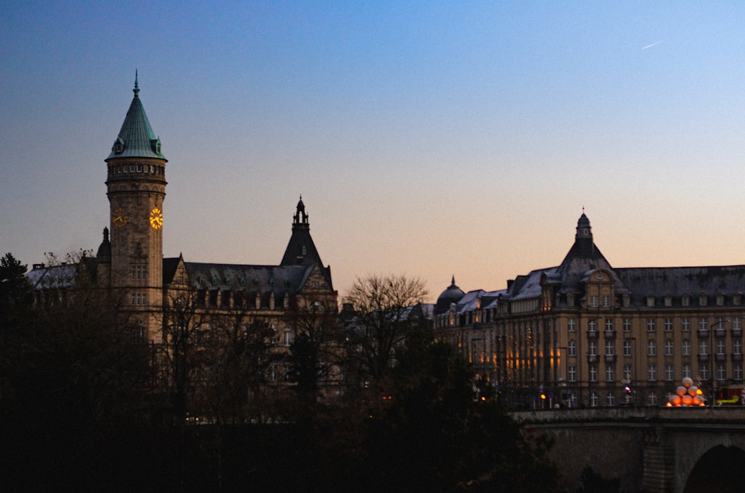 stablecoin services eu - A large building with a clock tower next to a bridge
