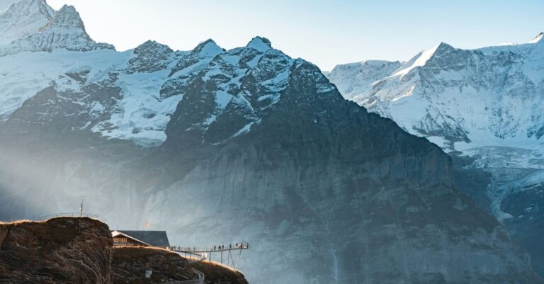 chf stablecoin - Explore the stunning snowcapped peaks and scenic walkways of the Swiss Alps at sunrise.