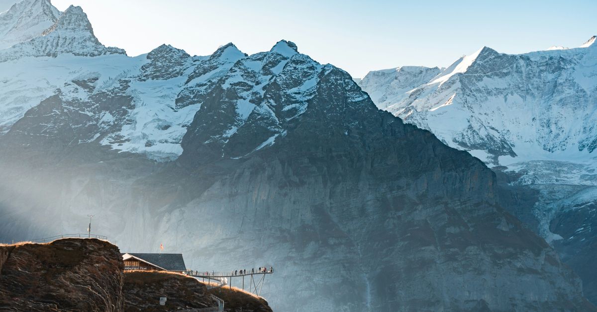 chf stablecoin - Explore the stunning snowcapped peaks and scenic walkways of the Swiss Alps at sunrise.