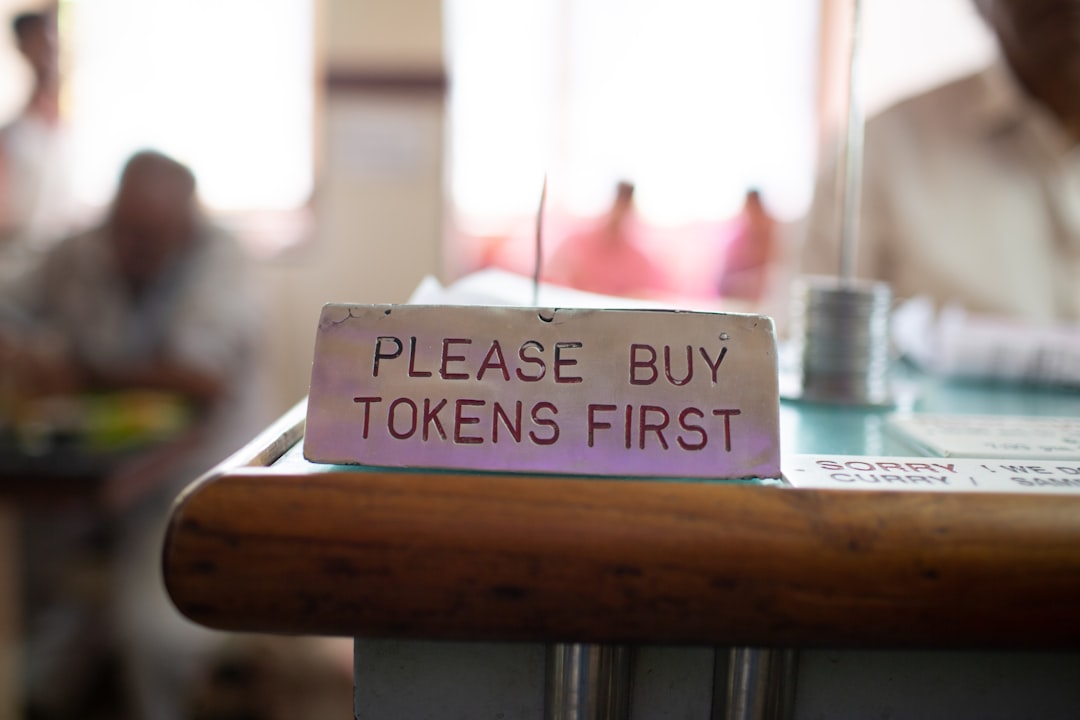 tokenised deposit network - a sign that says please buy token's first on a table