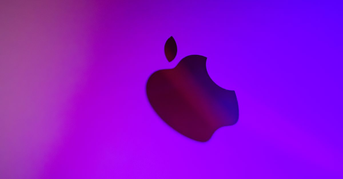 apple vision pro exec - A vibrant abstract image featuring a silhouette of an apple against a purple background.