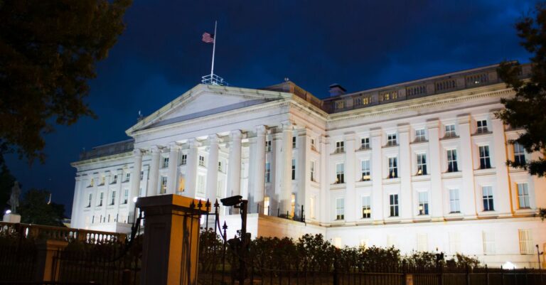 weaken financial watchdog - Stunning view of the U.S. Treasury Building illuminated against a twilight sky in Washington, DC.
