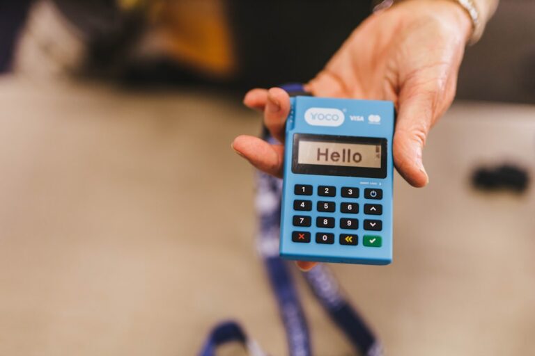 worldpay outage - a person holding a blue calculator in their hand