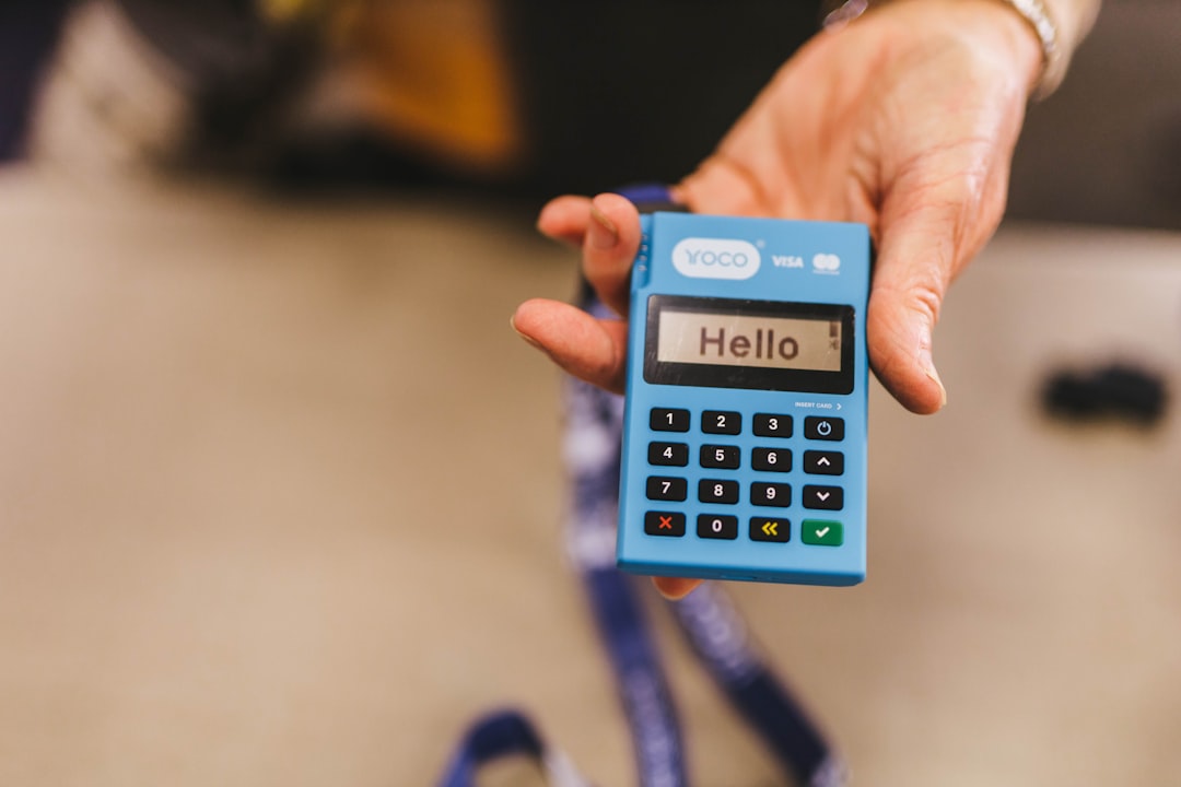 worldpay outage - a person holding a blue calculator in their hand