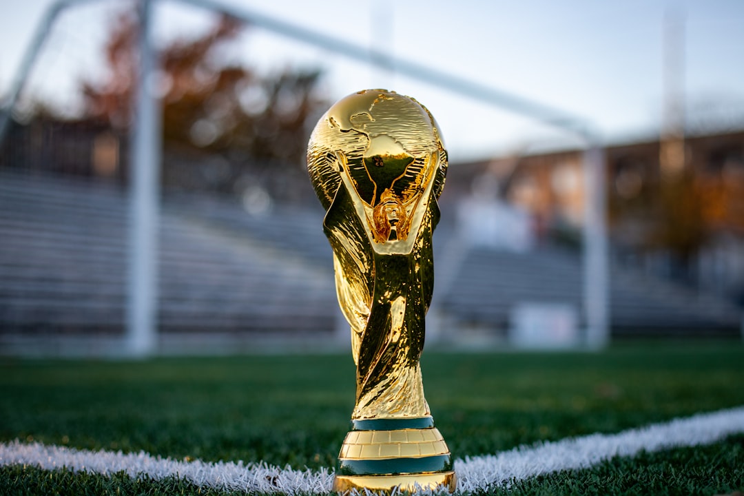 cross-border payments - a golden trophy sitting on top of a soccer field