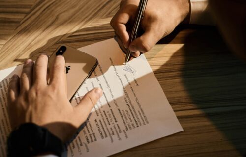 abn amro staff cuts - person writing on white paper