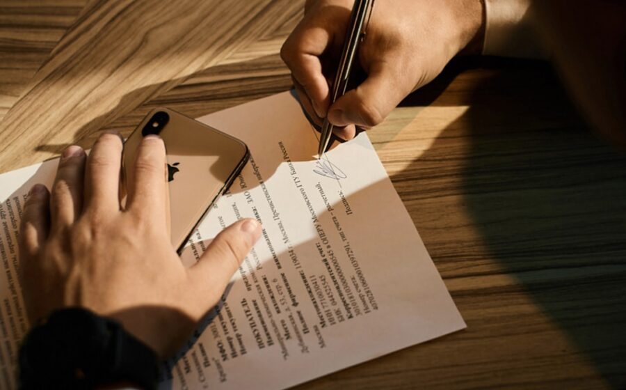 abn amro staff cuts - person writing on white paper