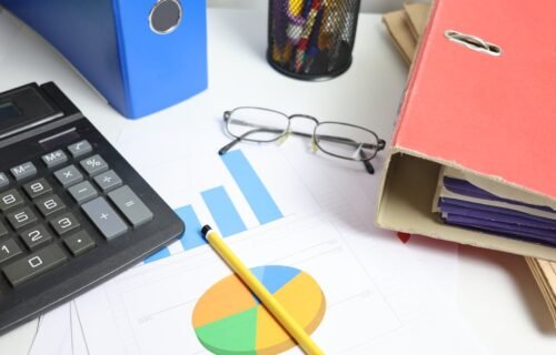 aci billing division sale - Desk with calculator, charts, and binders
