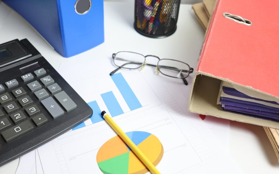 aci billing division sale - Desk with calculator, charts, and binders