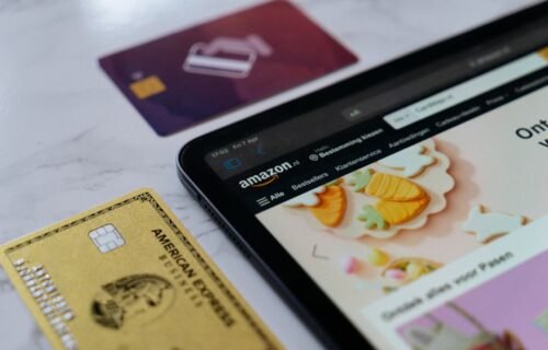 amazon business payments - a smart phone sitting next to a credit card