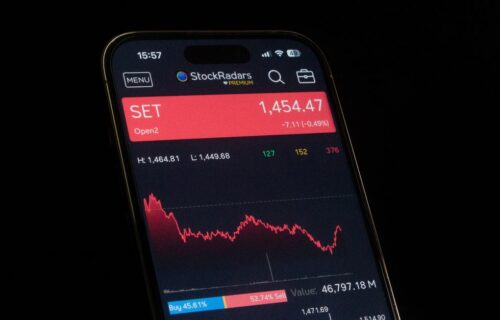 investment ai - Close-up of a smartphone showing a stock market chart with financial data and analytics.